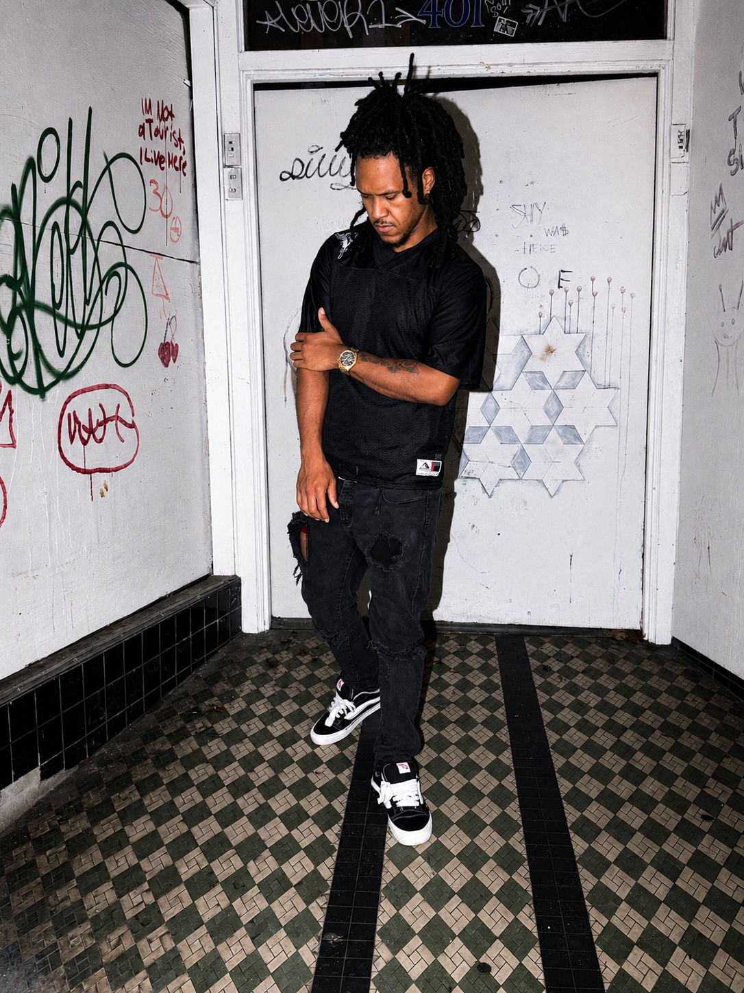 Angel Gear black mesh jersey worn in a graffiti stairwell